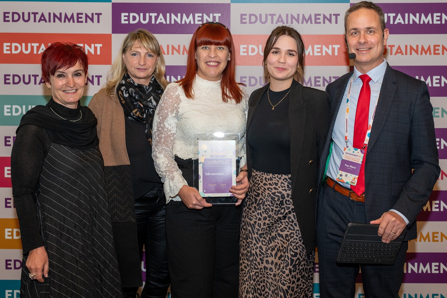 Iskraemeco representatives receiving'Top Investor in Learning 2024' award.