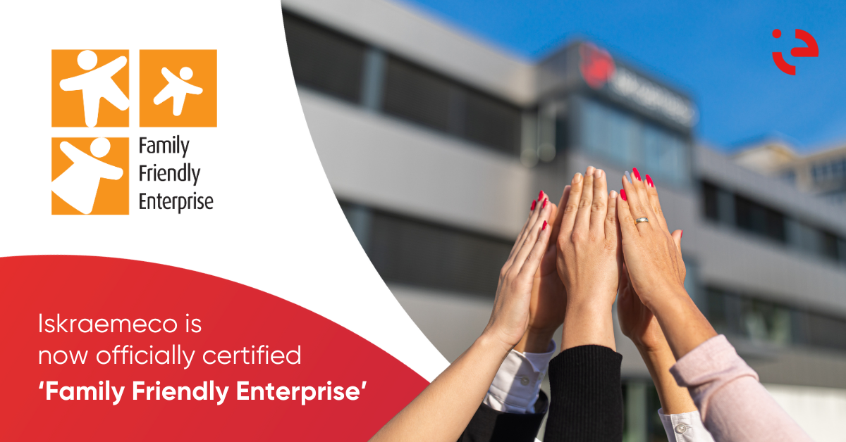 Iskraemeco team holding hands and celebrating the new certificate Family Friendly Enterprise